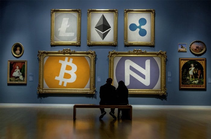 A dimly lit gallery room features a variety of framed cryptocurrency symbols on the walls, including Litecoin, Ethereum, Ripple, Bitcoin, and Nxt. Two people sit on a bench facing the artworks amidst the traditional paintings, discussing the launch's impact post-Cambridge Analytica.