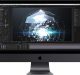 A black Apple iMac displaying a digital rendering software interface. The screen shows a 3D design of a glowing geometric structure with particles. Various tool panels and adjustment settings are visible around the workspace, powered by custom Mac chips for seamless performance.