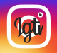 A colorful gradient background transitioning from purple to orange. Centered is a white play button enclosed within a white square. Inside the square, stylized black text reads "IGTV," marking its launch on Instagram TV.