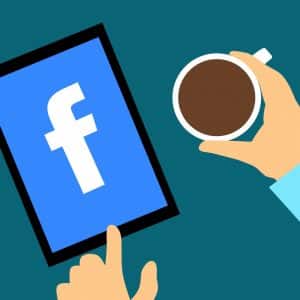 Illustration of a person holding a coffee cup in their left hand and a tablet displaying the Facebook logo in their right hand. The background is teal, and both of the person's hands are visible. The tablet screen is blue with a white Facebook "f" logo, hinting at concerns over recent privacy glitches.