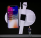 A person stands on stage presenting Apple's latest release, a charging pad that simultaneously powers a smartphone, smartwatch, and wireless earbuds. The smartphone screen displays it is charging at 78%, the smartwatch at 61%, and the earbuds case at 48%. This innovation recalls the ambition of AirPower.