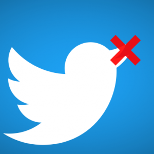 A white Twitter bird logo on a blue background with a red X over its beak, implying the bird is being silenced or censored due to online abuse.