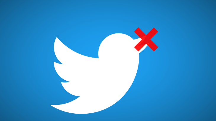 A white Twitter bird logo on a blue background with a red X over its beak, implying the bird is being silenced or censored due to online abuse.