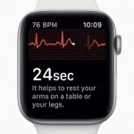 A smartwatch, possibly an Apple Watch, displaying a heart rate of 76 BPM and a time of 10:09. The screen shows an ECG reading in progress with a message stating, "24 sec. It helps to rest your arms on a table or your legs.