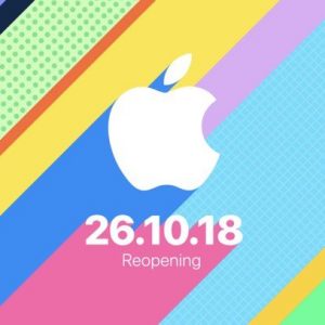 Colorful diagonal stripes with varying patterns surround the white Apple logo in the center. Below the logo, text reads "26.10.18 Reopening" at Apple's flagship store in London.