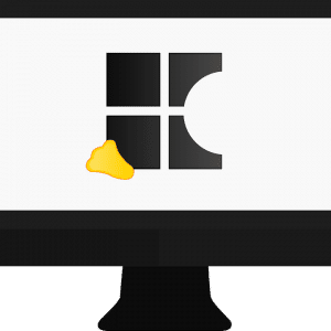 A black computer monitor displaying a simplified depiction of the Windows logo, which has one pane appearing incomplete as if partially eaten, and a small piece of cheese positioned near the bottom left of the logo—a subtle Micro Dig at Apple.