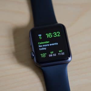 A sleek black Apple Watch displaying a calendar notification reads "No more events today." The time shown is 16:32, and it also features weather information at 18°C, along with times for SF at 08:32 and NY at 11:32. Opt into the replacement program for seamless repairs if needed.