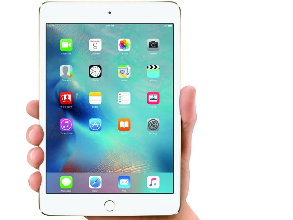 A hand holding a gold iPad Mini with a white front, believed to be the iPad mini 5. The screen displays several app icons, including FaceTime, Calendar, Photos, Camera, Maps, and Settings against a colorful abstract background. With its Touch ID sensor on the home button, this leak suggests major updates ahead.