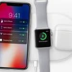 Reports suggest the Apple AirPower is expected imminently. A wireless charging pad charges three Apple devices: an iPhone displaying a battery status screen, an Apple Watch showing a 63% charge, and AirPods in an open charging case. A single charging cable is connected to the pad.