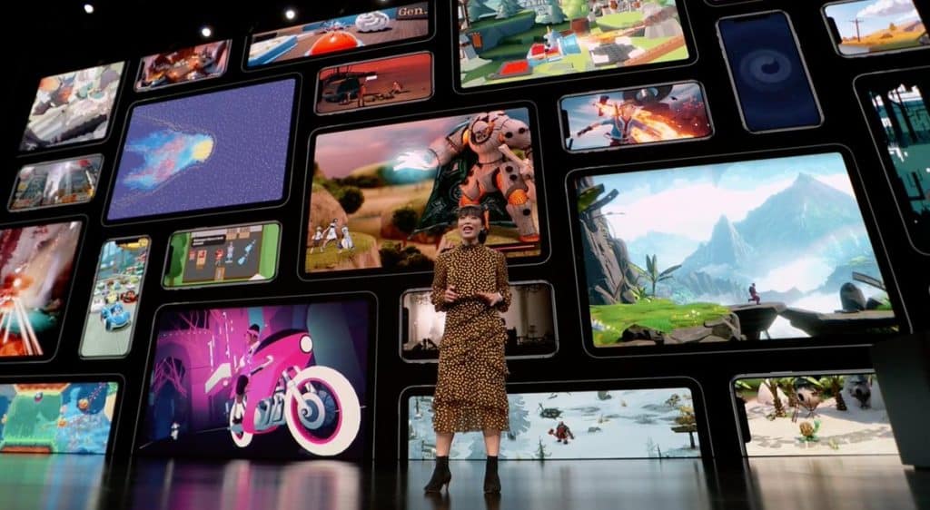 A woman in a leopard print dress stands on stage in front of a large screen displaying multiple colorful images from Apple Arcade. The images behind her feature various themes and art styles, including futuristic, nature, and fantasy elements from the games subscription service.