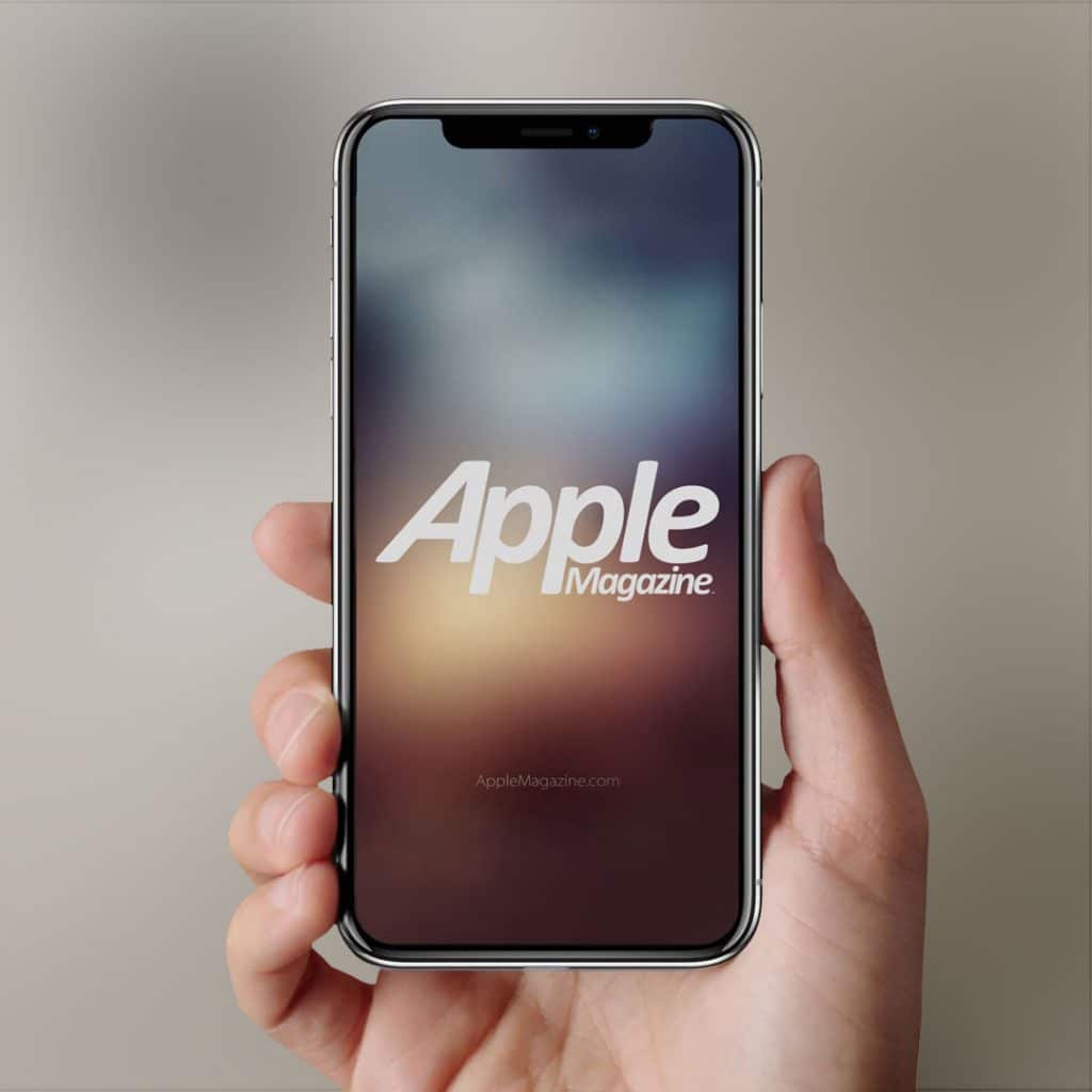 A hand holding an iPhone with the screen displaying a blurred background and the text "Apple Magazine" prominently featured in the center. The web address "AppleMagazine.com" is visible below the main text, reflecting Apple's foray into digital media as it takes up the gauntlet of streaming innovation.