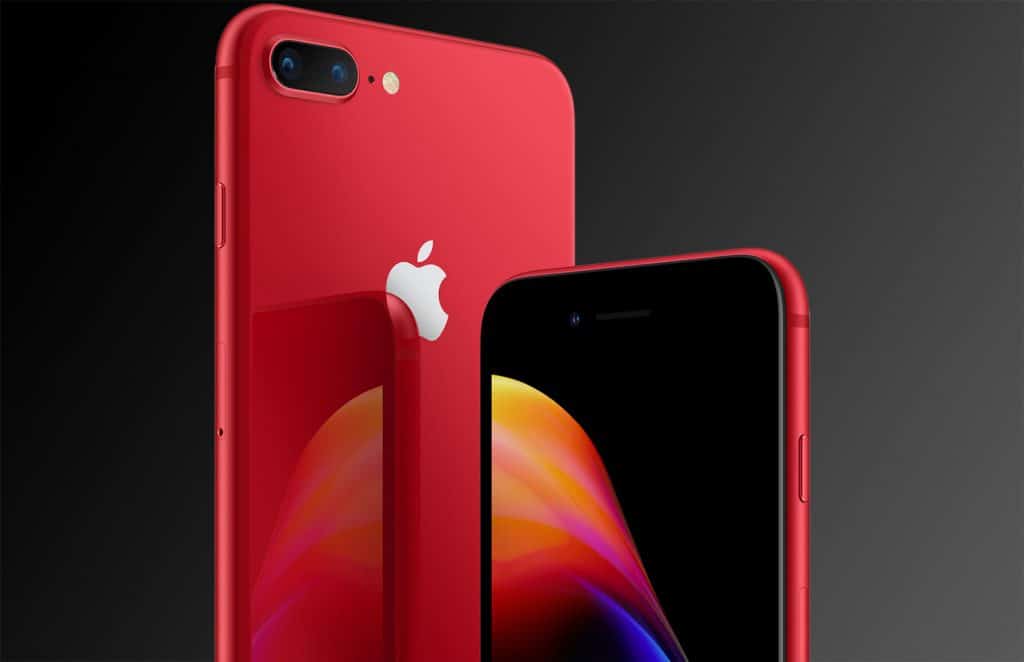 A close-up image of a discounted red 2018 iPhone model with a reflective back and a dual camera setup. The phone's screen is partially visible, showing a colorful abstract wallpaper. The Apple logo is prominently displayed on the back, while the background features a gradient of dark shades.