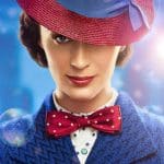 A woman in a blue coat, white polka-dotted shirt, and red polka-dotted bow tie smiles slightly. She wears a red hat with a blue band tilted over one eye. The background is blue with floating bubbles and a burst of light on the right side, reminiscent of *Mary Poppins Returns* you might find reviewed on iTunes.