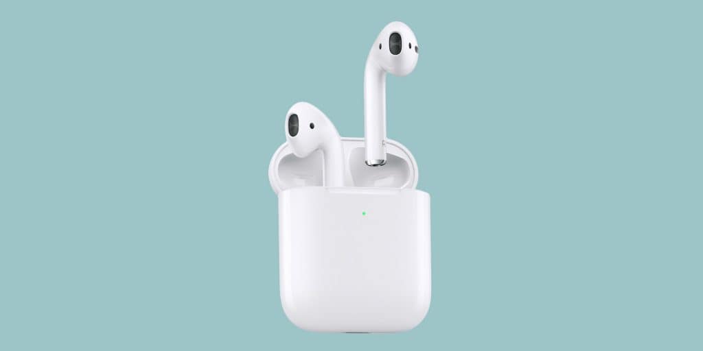 A pair of white Apple AirPods are shown resting in an open charging case. The case is white with a small green indicator light on the front. The background is a solid light teal color, showcasing the sleek design introduced in 2019.