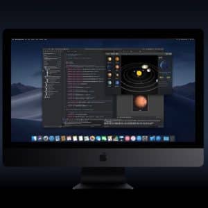 A desktop computer screen displays a coding environment with a dark-themed code editor, showing various lines of code. A smaller window overlays the editor, depicting a solar system model. The background is dark, the operating system is macOS, with Apple Music and Apple TV apps visible in the dock.