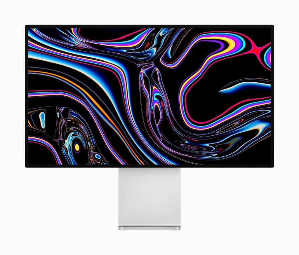 A computer monitor displaying a vibrant, abstract design with swirling patterns of neon colors including pink, blue, and yellow on a black background. The sleek monitor, presumably part of an Apple announcement for the new Mac Pro, features thin bezels and a silver stand.