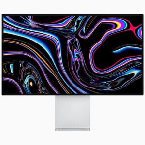 A computer monitor displaying a vibrant, abstract design with swirling patterns of neon colors including pink, blue, and yellow on a black background. The sleek monitor, presumably part of an Apple announcement for the new Mac Pro, features thin bezels and a silver stand.