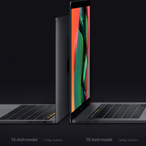 Two open MacBook laptops, a 13-inch MacBook Pro and a 15-inch model, are placed side by side on a dark background. Screens facing each other create a mirror-like appearance. The refreshed 13-inch model weighs 1.37 kg with a thickness of 14.9 mm, while the FCC-approved 15-inch model is 1.83 kg and 15.