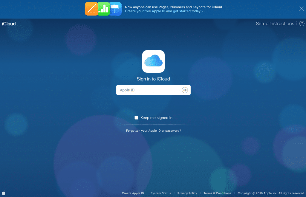 Screenshot of the iCloud sign-in page with a background of blue circles. The page prompts for an Apple ID, with options to keep signed in and links for forgotten Apple ID or password, creating an Apple ID, system status, privacy policy, terms & conditions, and copyright information. Additionally, it supports Touch ID and FaceID for secure access.