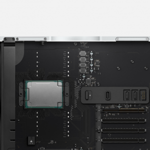 Close-up view of the interior of a high-performance computer tower, reminiscent of the Mac Pro, showcasing the motherboard with a mounted CPU, various connectors, slots for expansion cards, and a cooling mechanism setup. Silver outer frame is visible at the top.