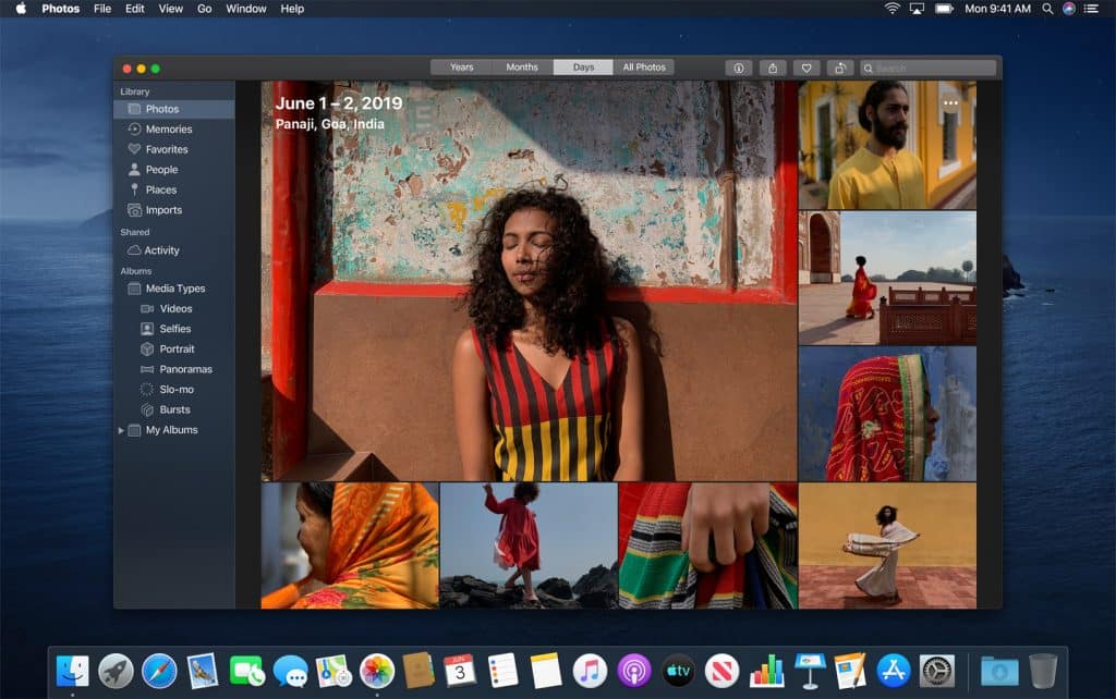 A computer screen displays the Photos app open on a macOS Catalina desktop. The library shows a collection titled "June 1-2, 2019, Panaji, Goa, India." Various vibrant photos depict people and scenes, including a woman in a striped dress, colorful attire, and scenic backgrounds.