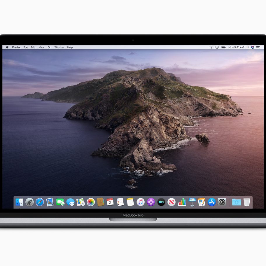 A MacBook Pro laptop displaying a serene landscape with a rocky island surrounded by calm ocean waters at dusk. The dock at the bottom of the screen shows various application icons. The laptop is open and viewed from the front.