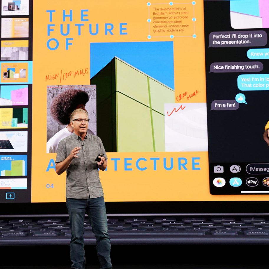 A person standing on a stage giving a presentation in front of a large screen. The screen displays a graphic about "The Future of Architecture" with colorful images and text. Part of the screen also shows a chat conversation with cartoon-like emoji reactions.