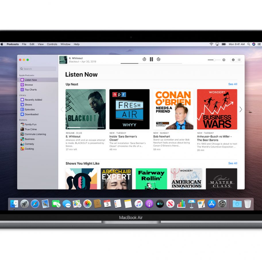 A MacBook Air laptop displaying the Apple Podcasts app on its screen. The app's interface shows the "Listen Now" section, featuring various podcast episodes and recommendations, including podcasts like "Fresh Air" and "Conan O'Brien Needs A Friend.