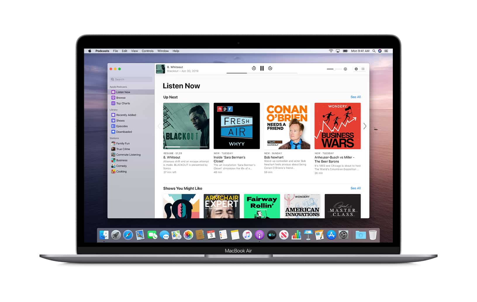 A MacBook Air laptop displaying the Apple Podcasts app on its screen. The app's interface shows the "Listen Now" section, featuring various podcast episodes and recommendations, including podcasts like "Fresh Air" and "Conan O'Brien Needs A Friend.