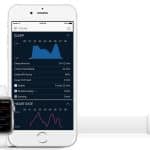 A smartwatch, likely an Apple Watch, displays heart rate data on the left, while an iPhone in the center shows new details on a detailed sleep analysis screen. A small white rectangular sensor with an orange tag is placed to the right, likely used for sleep tracking or health monitoring.