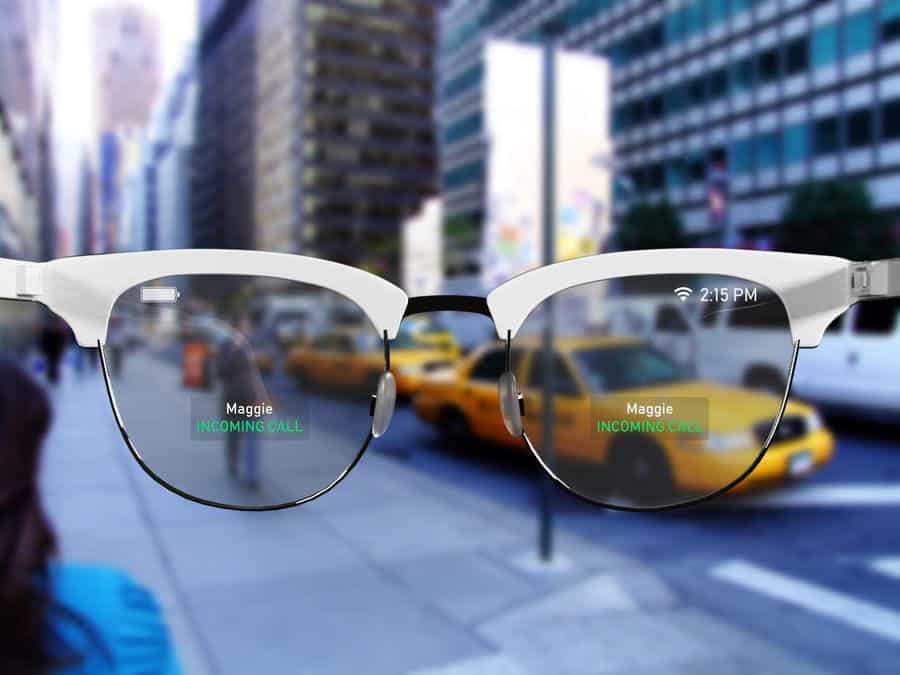 A view of a city street filled with taxis and tall buildings, seen through Apple Glasses displaying an incoming call from "Maggie" and the time, 2:15 PM, on the lenses.