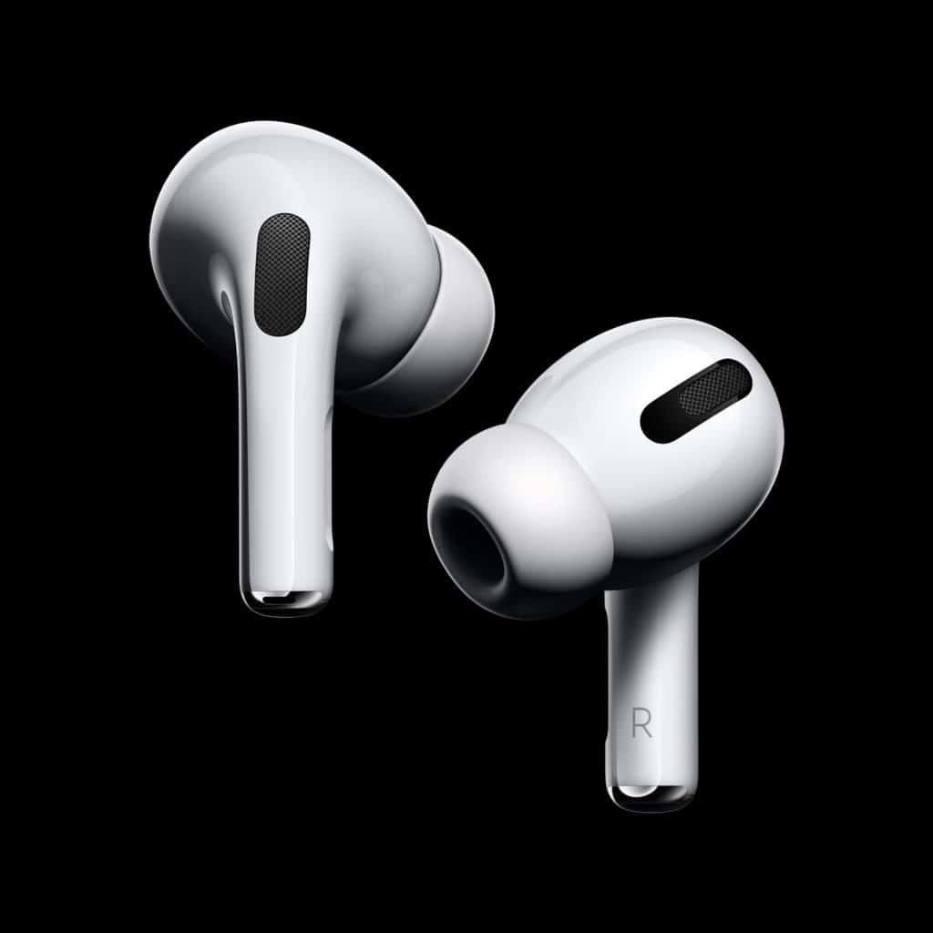 A close-up image of two white Apple AirPods Pro with silicone ear tips. The earbud labeled "R" indicates the right ear; both are designed with black speaker grilles. The background is black, highlighting the glossy finish of these $249 earbuds.