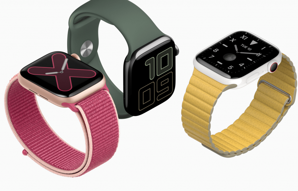 A display of three smartwatches. From left to right: a rose gold watch with a pink band and minimalist 'X' face design, a black watch with a green band featuring the large digits '10' and '09,' and a silver Apple Watch showcasing its new sleep tracking feature with a yellow band displaying the time.