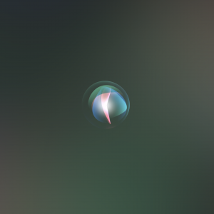 A circular, illuminated Siri icon floats against a dark, gradient background. The icon features swirling colors of blue, pink, and white, symbolizing the Apple Siri virtual assistant, reminiscent of modern communication apps like WhatsApp and Skype.