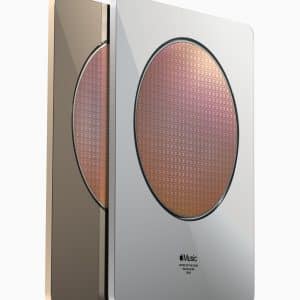 Two metallic plaques, one gold and one silver, with a circular pattern in the center resembling a microchip. The plaques are aligned side by side at a slight angle. Text below the circular pattern on the front plaque reads "Apple Music Award 2020." They were unveiled at the Steve Jobs Theater.