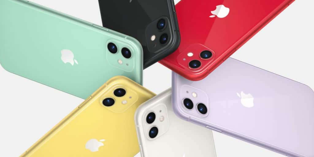 Several 2020 iPhones arranged in a fan-like display, showcasing different colors including green, black, red, lavender, white, and yellow. Each phone features dual rear cameras and the Apple logo. Under-display fingerprint scanners enhance these stylish devices set against a plain white background.