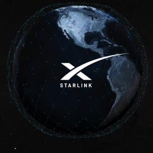 Image of Earth from space with the Americas prominently displayed. An overlay shows a network of connected lines around the planet, highlighting IoT connectivity. The logo for Starlink, featuring a stylized "X" and the word "Starlink," is centered on the image. The backdrop is a starry sky.
