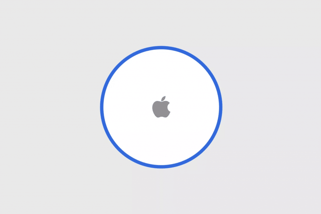 Image of Apple's AirTag. The AirTag, part of the highly anticipated Q3 launch referenced by Kuo, is a small, circular device with a white front featuring the Apple logo in the center. It has a blue outline around it and is set against a light grey background.