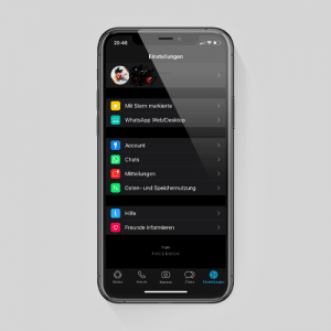 A smartphone displaying the Settings menu of a WhatsApp account on iOS in Dark Mode. The interface is in German, featuring options like Account, Chats, Notifications, and Data and Storage Usage. The device is set against a plain grey background.