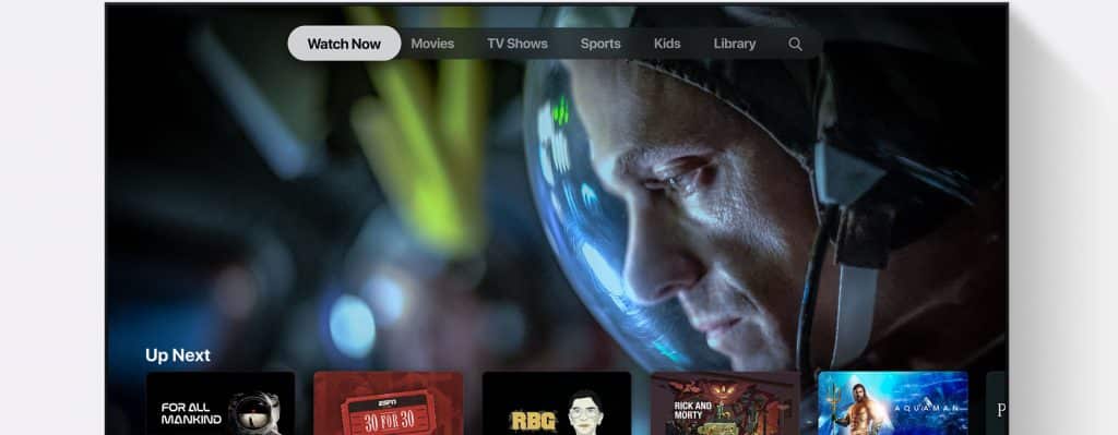 A streaming service interface is displayed on an LG screen, featuring a close-up of an astronaut's face in a helmet. The top menu includes options like Watch Now, Movies, TV Shows, Sports, Kids, and Library. The "Up Next" section shows various TV show and movie thumbnails.