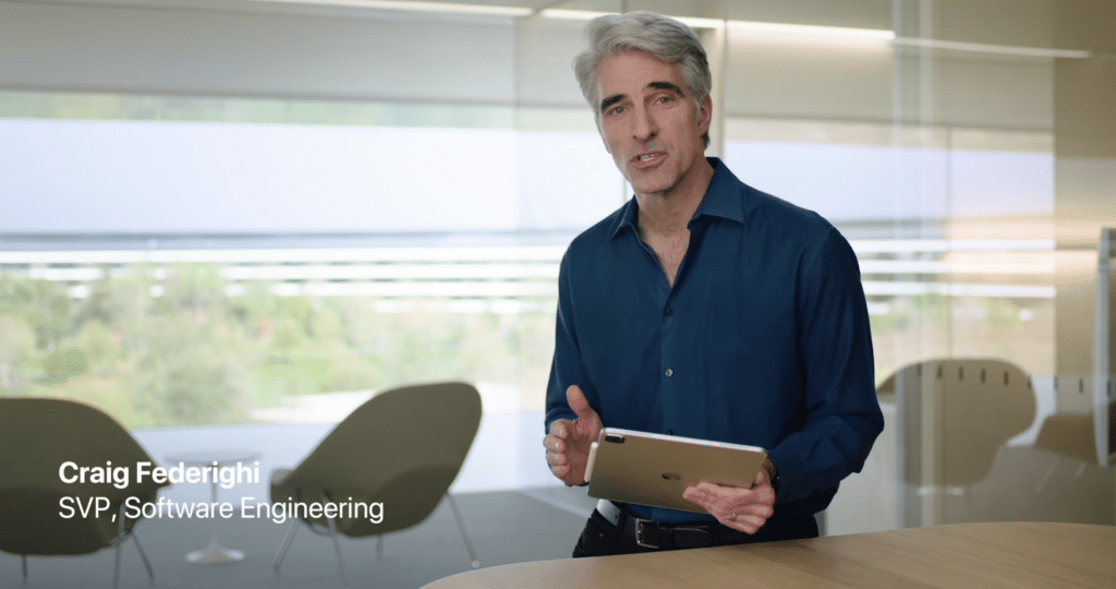 A man with gray hair wearing a blue shirt stands in an office at Apple Campus holding an iPad Pro. The text on the left reads "Craig Federighi, SVP, Software Engineering." The background features large windows and chairs.