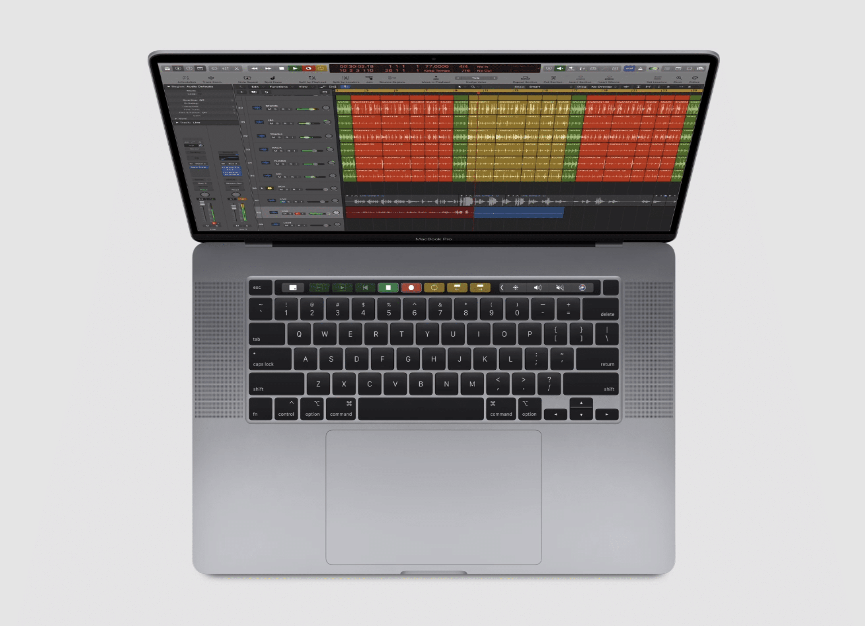 A MacBook Pro with an open Logic Pro music production software on the screen, showing a multi-track project with different colored audio waveforms. Powered by ARM-based processors, the laptop's keyboard and trackpad are visible, and the screen is vivid, set against a light gray background.