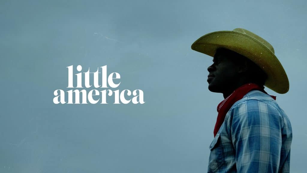 A person in profile wearing a cowboy hat and a plaid shirt stands against a dark, cloudy sky. The words "Little America" are displayed in large white letters on the left side of the image, hinting at an anticipated content premiere. The person appears to be looking into the distance.