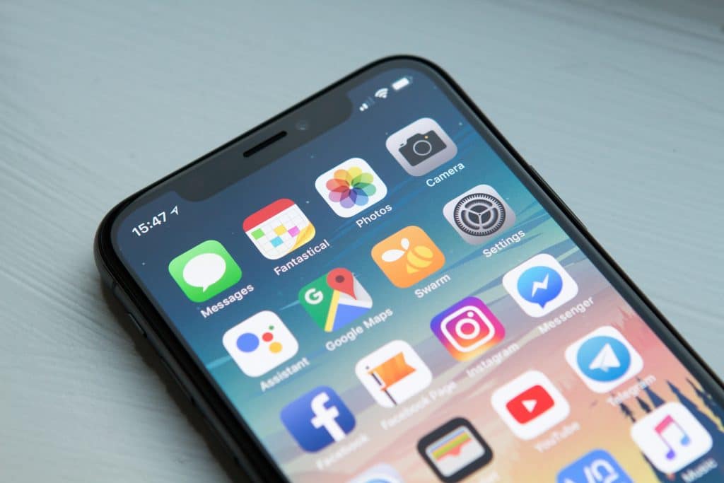 A smartphone screen displaying various app icons, including Messages, Fantastical, Photos, Camera, Assistant, Google Maps, Swarm, Settings, Facebook, Instagram, WhatsApp, and Messenger. Notably featuring apps from the App Store and coronavirus apps. The time at the top left is 15:47.
