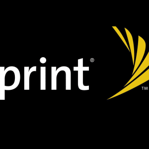 Bold white letters spell "Sprint®" against a black background, accompanied by a yellow, wing-shaped logo to the right of the text. The yellow logo consists of three intersecting curved lines. A small "TM" symbol appears at the bottom right of the logo as Sprint begins to phase out in favor of T-Mobile.