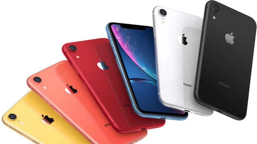 A fan-like arrangement of six refurbished iPhone XRs in different colors: yellow, coral, red, blue (with screen facing forward), white, and black. Each $499 iPhone displays the Apple logo on the back.