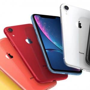 A fan-like arrangement of six refurbished iPhone XRs in different colors: yellow, coral, red, blue (with screen facing forward), white, and black. Each $499 iPhone displays the Apple logo on the back.