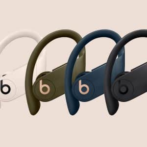 Four Beats by Dre Powerbeats Pro wireless earphones are shown, each in new colors: ivory, moss, navy, and black. The earphones feature an over-ear hook design for a secure fit and have the Beats logo prominently displayed on the side. Experience Apple-quality sound with every beat.