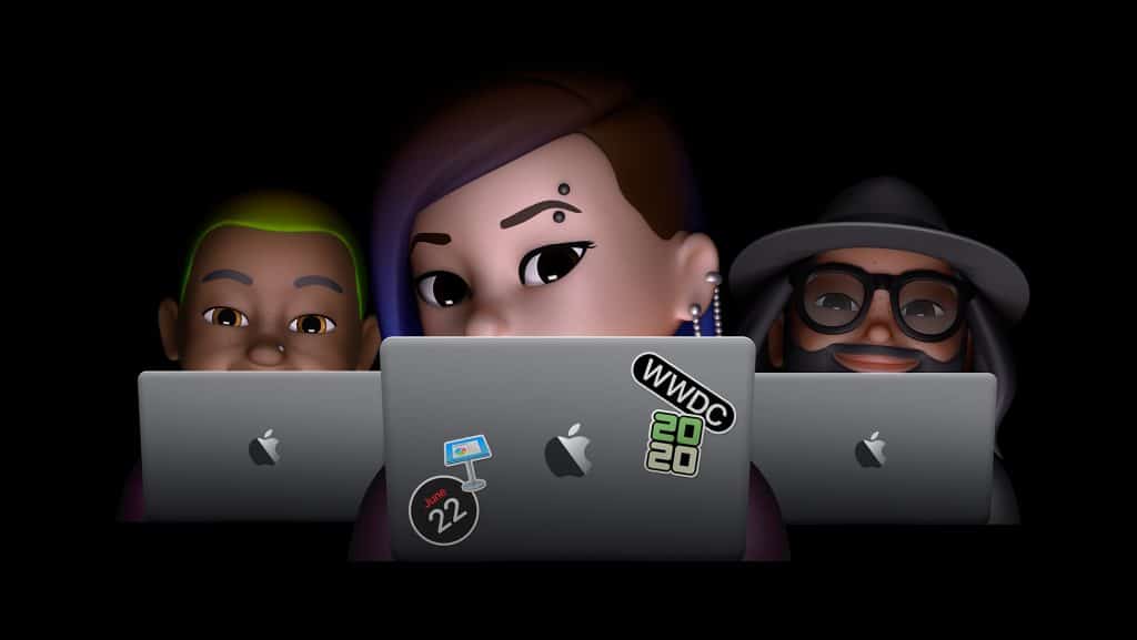 Three Memojis sit in front of MacBook laptops, each branded with distinct stickers: one with a WWDC 2020 sticker, one with a sticker of a Mac Finder icon, and one with a sticker that reads “June 22”. The black background sets the stage for this virtual Apple gathering.