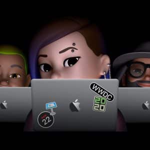 Three Memojis sit in front of MacBook laptops, each branded with distinct stickers: one with a WWDC 2020 sticker, one with a sticker of a Mac Finder icon, and one with a sticker that reads “June 22”. The black background sets the stage for this virtual Apple gathering.